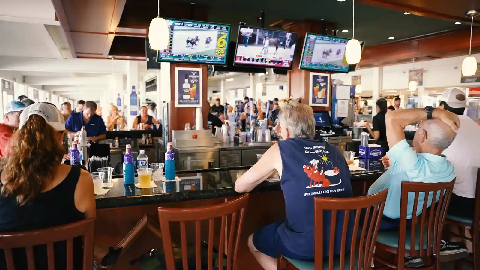 riders up bar patrons watching monitors